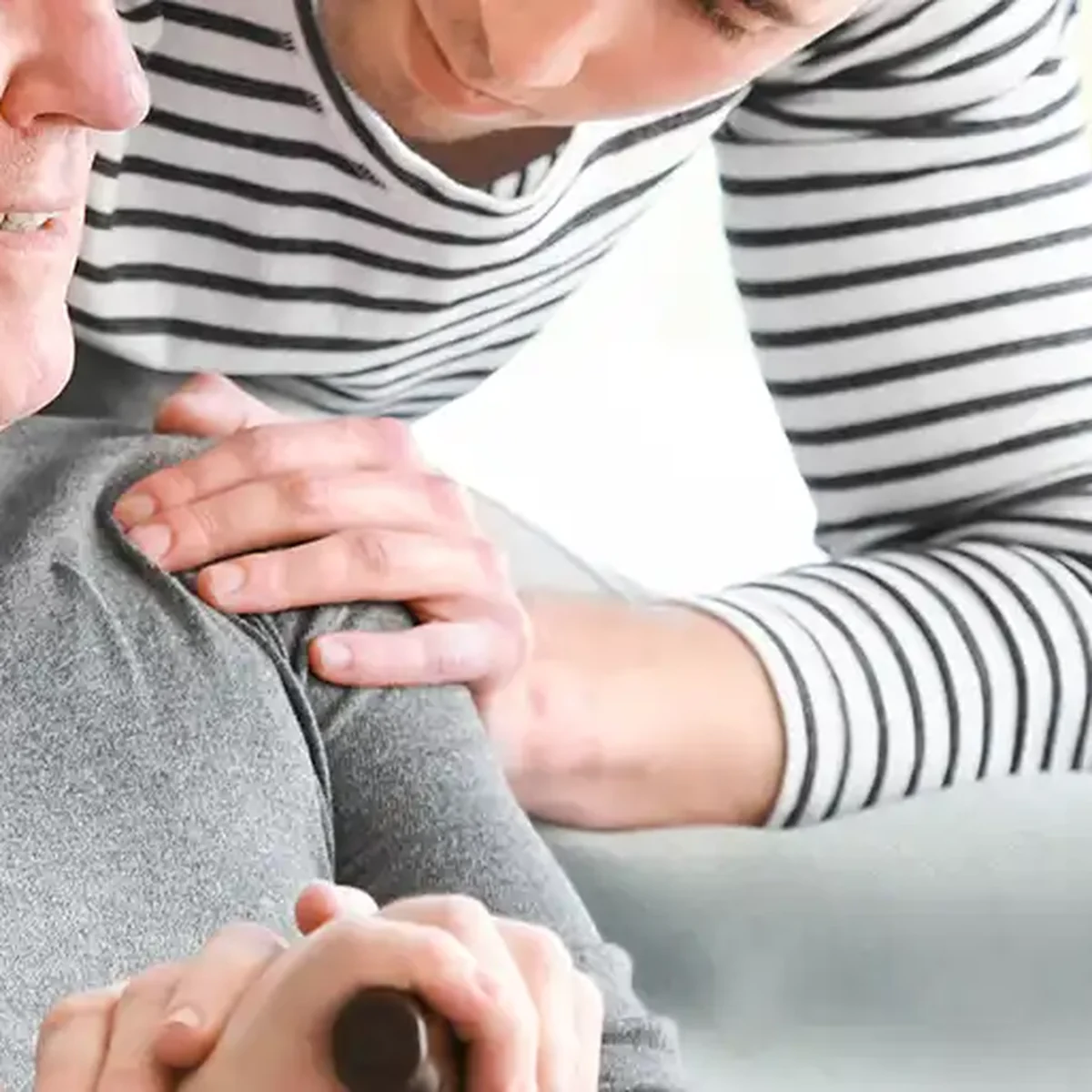 Compassionate caregiver supporting an older adult resident